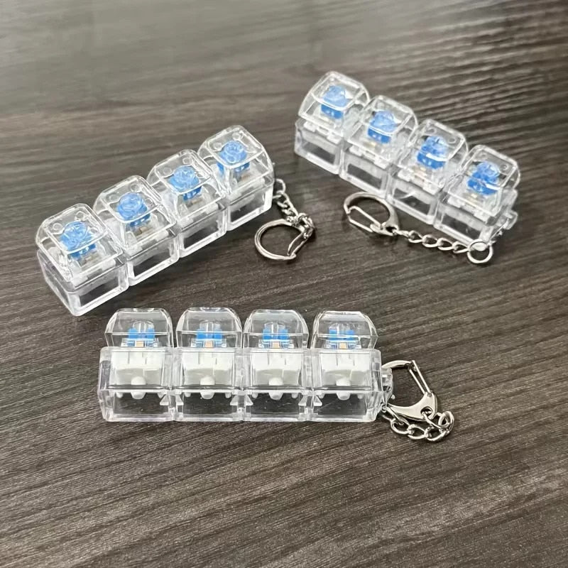 Breloc Antistres cu 4 Taste Mecanice, Jucarie Fidget cu Lumini LED Multicolore, Clicky Switch, Transparent